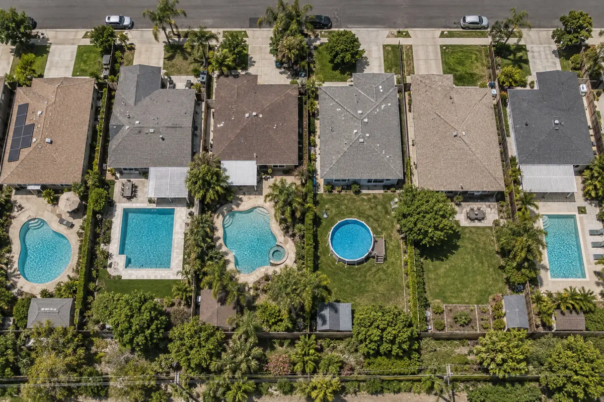 Backyard pools in a US suburb. EIA's 2024 survey found 11.2% of single-family detached homes had their own pool.