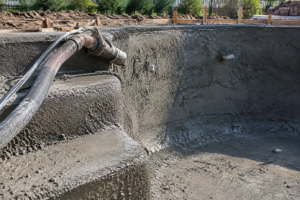 The pool shell, shown here being sprayed, is the core of what a pool permit covers.